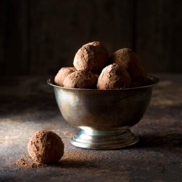 Chocolate ganache truffles in a metal bowl.