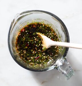 Marinade being stirred in a cup.