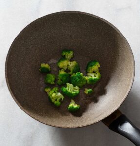 Cooked broccoli in a pan.