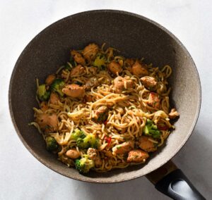 Chicken hokkien noodle stir fry in a pan.