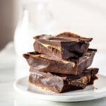 A stack of caramel toffee shards on a plate.