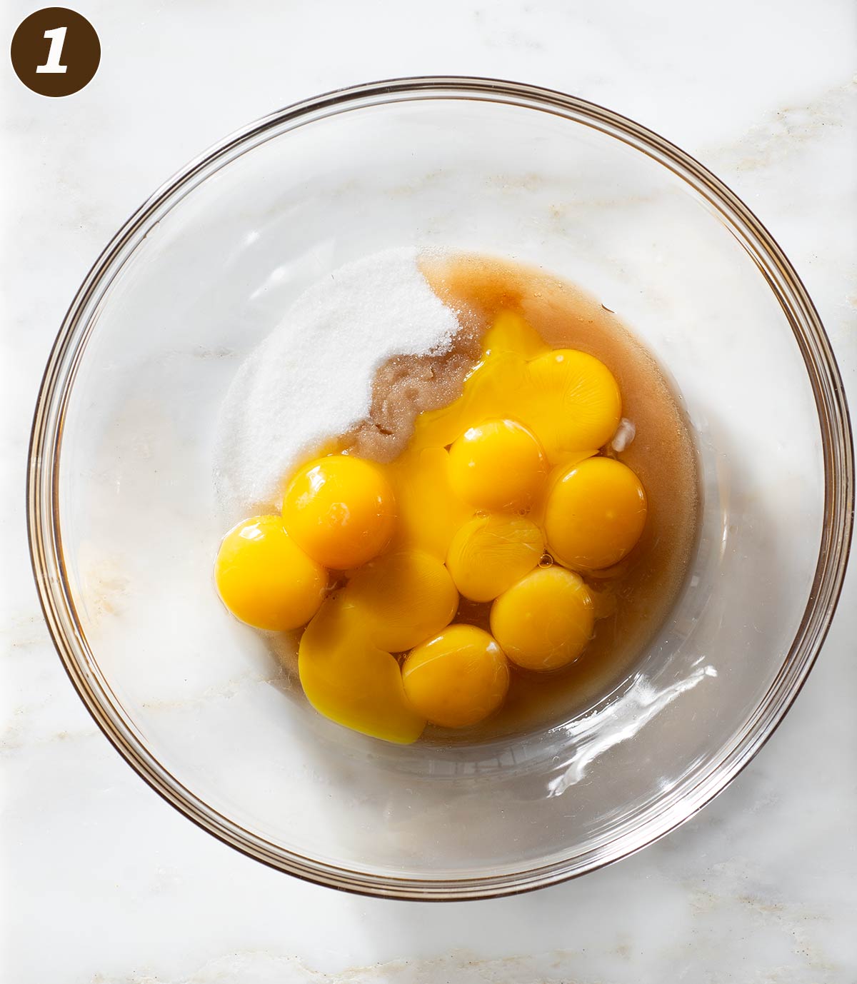 Egg yolks, sugar and vanilla extract in a bowl.