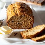 Sliced banana bread with butter.