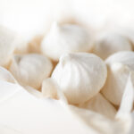 Cardamom meringue cookies in a white bakery box.