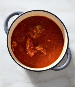 Tomato chicken curry in a Dutch oven.
