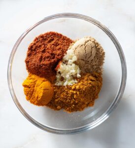 Curry spices in a glass bowl.