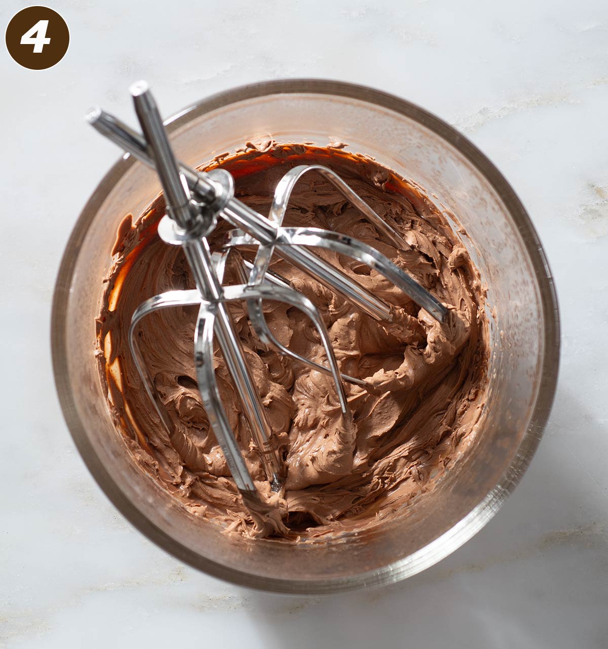 Whipped chocolate mousse frosting in a bowl.