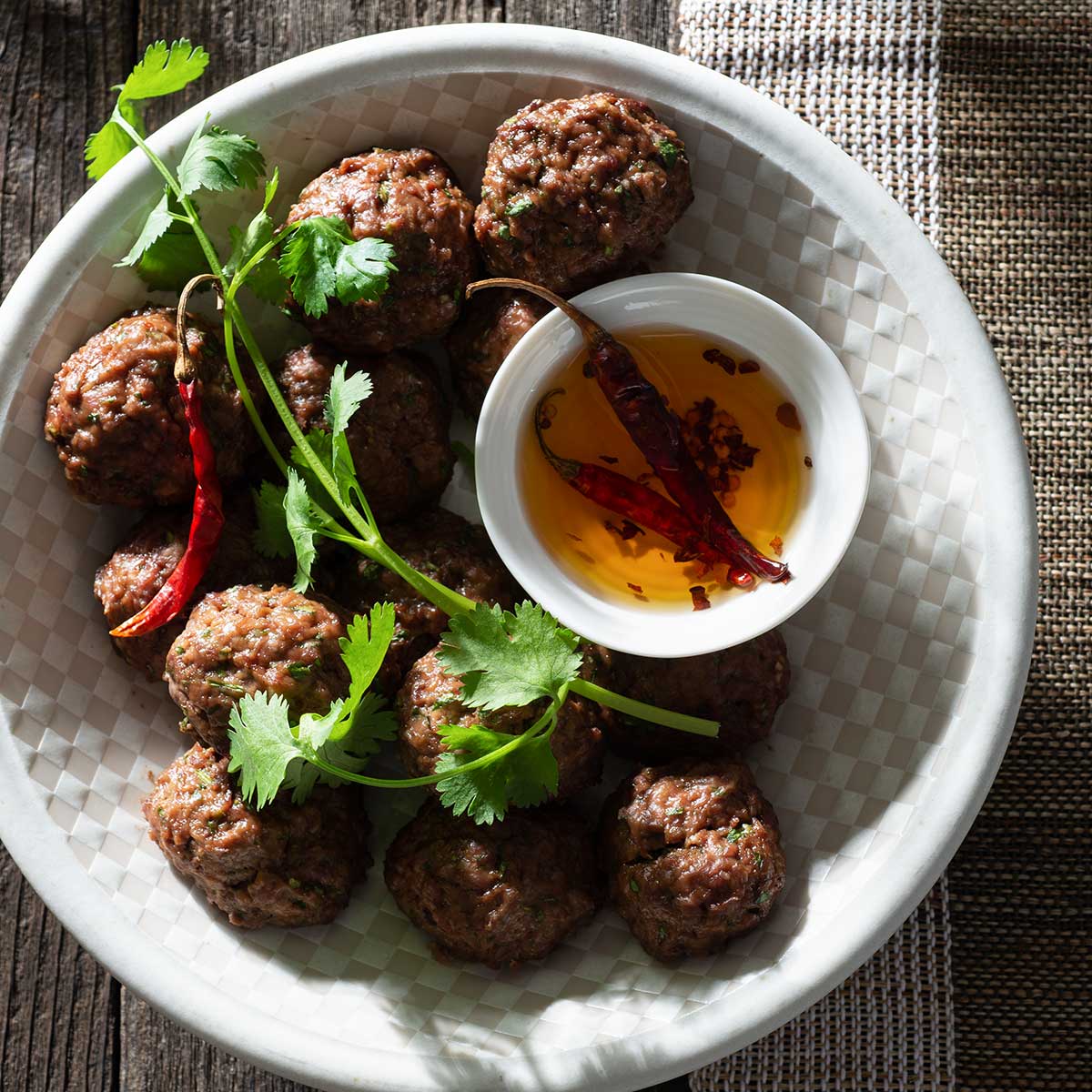 Cilantro Asian beef meatballs with dipping oil.