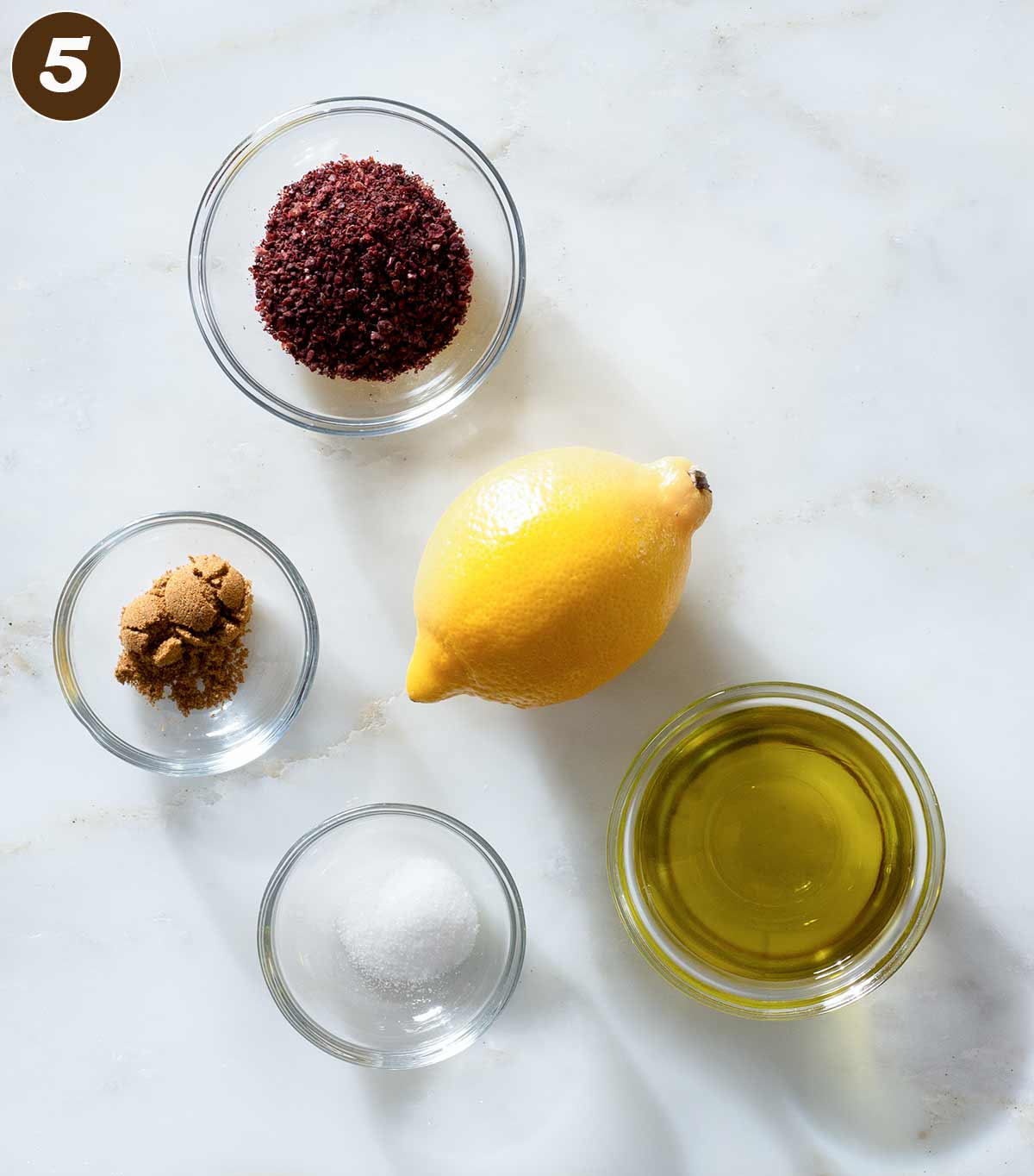 Lemon sumac dressing ingredients on a table.