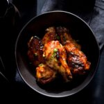Soy sauce-marinated chicken wings in a bowl.