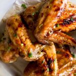 Maple orange-glazed chicken wings on a plate.