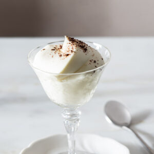White chocolate mousse in a fancy glass.