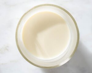 Cream and melted white chocolate in a bowl.