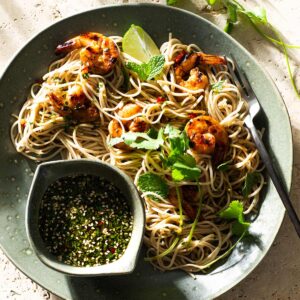 Cold Asian noodle salad with dressing on a plate.