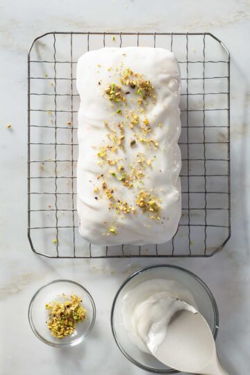 A glazed loaf cake on a wire rack.