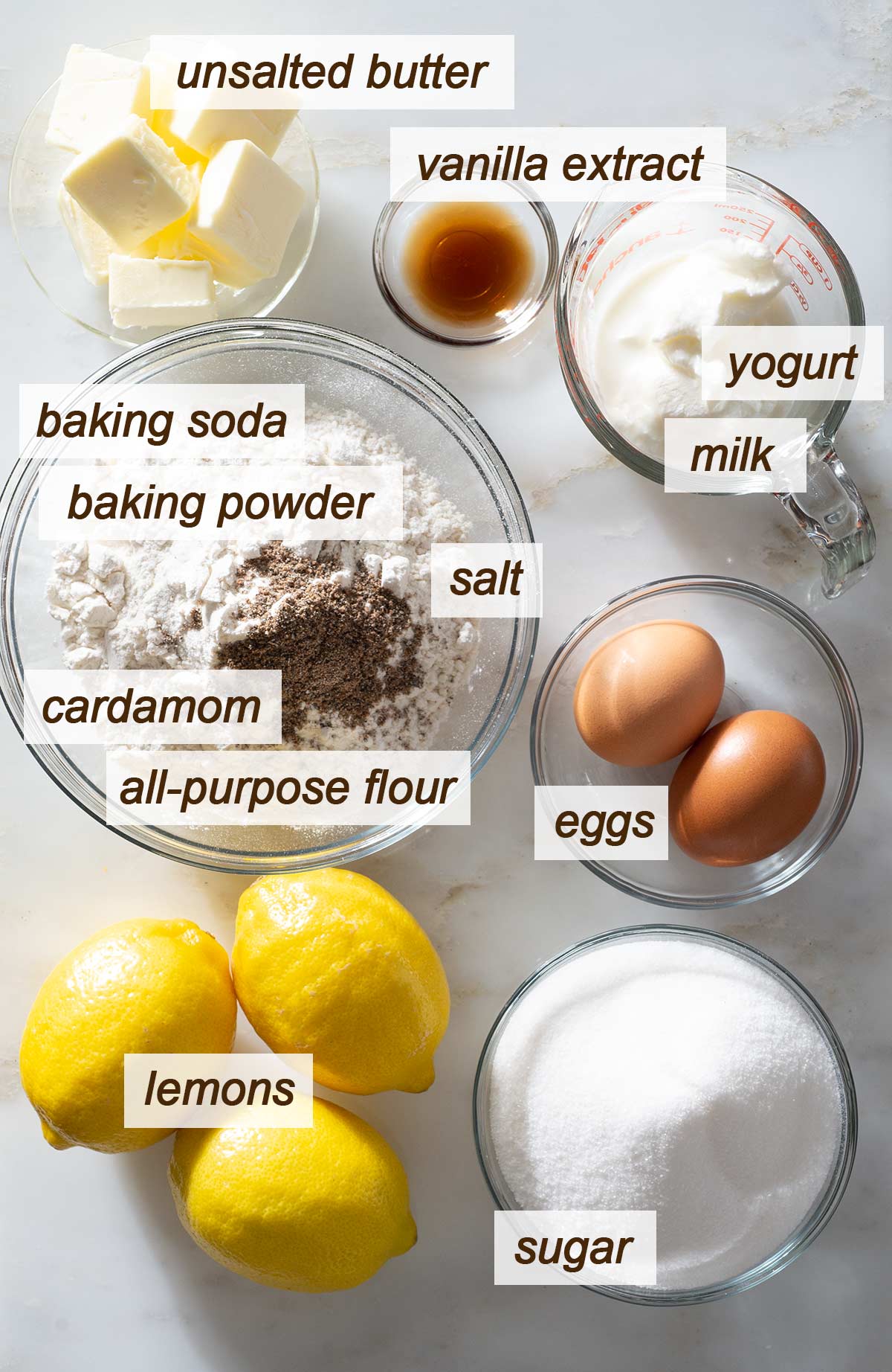 Butter, vanilla extract, yogurt, milk, eggs, sugar, lemons, salt, flour, cardamom, baking powder and baking soda.