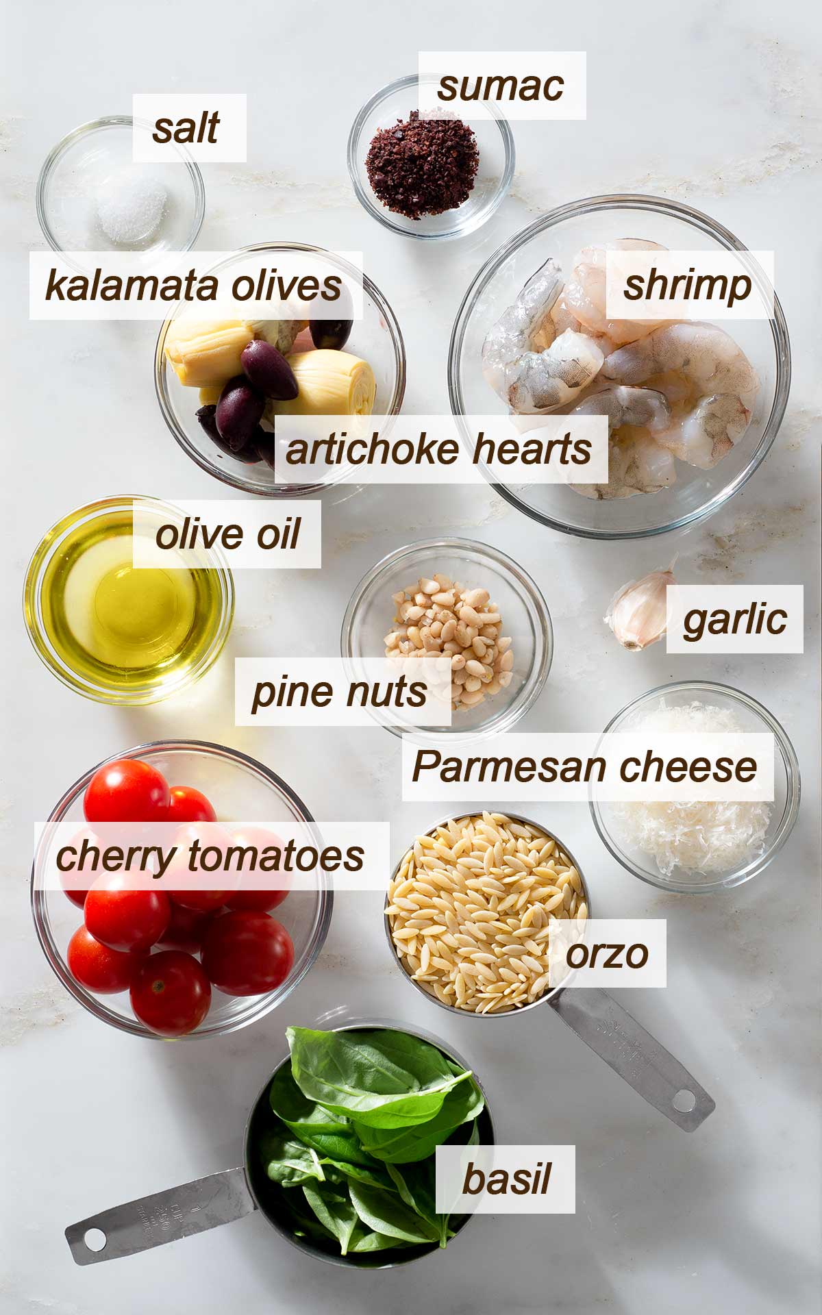 Orzo pesto salad ingredients on a table.