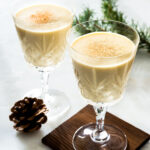 Two elegant glasses with spiced eggnog.