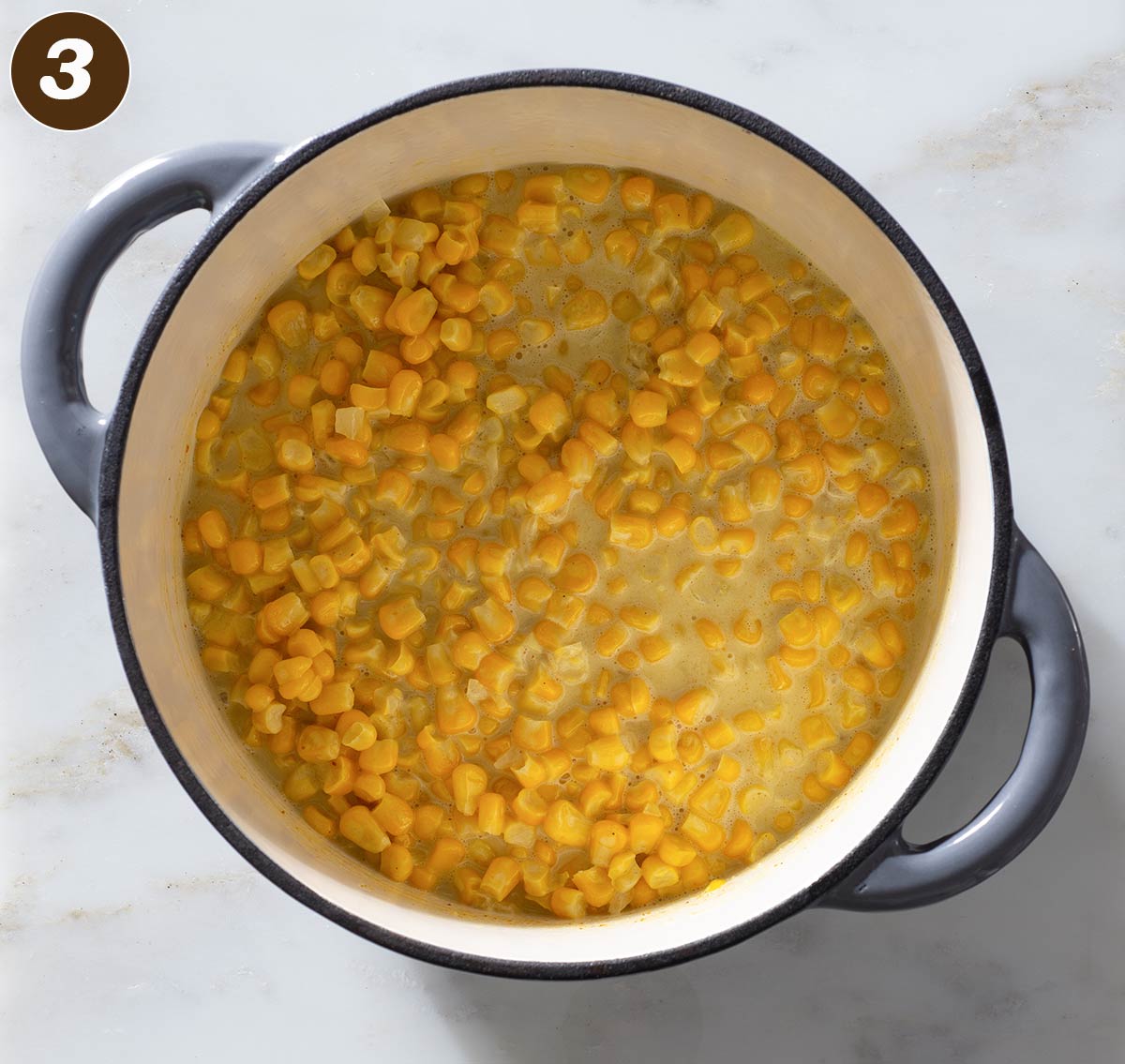 Curry corn in a Dutch oven.
