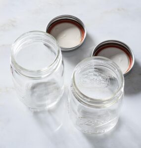 Rinsed, empty canning jars with lids.