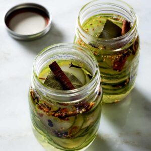 Two jars with cinnamon clove sweet pickles.