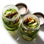 Sweet pickles with cinnamon and cloves in jars.