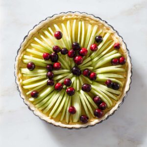 An unbaked cranberry apple frangipane tart.
