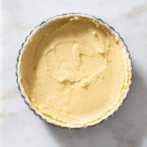 Frangipane filling in an unbaked tart crust.