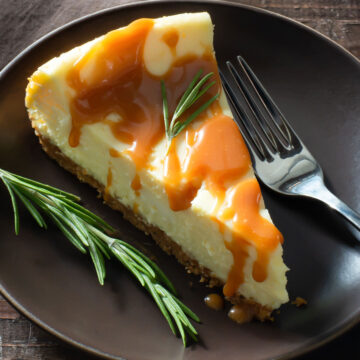 A slice of goat cheese cheesecake with rosemary caramel sauce.