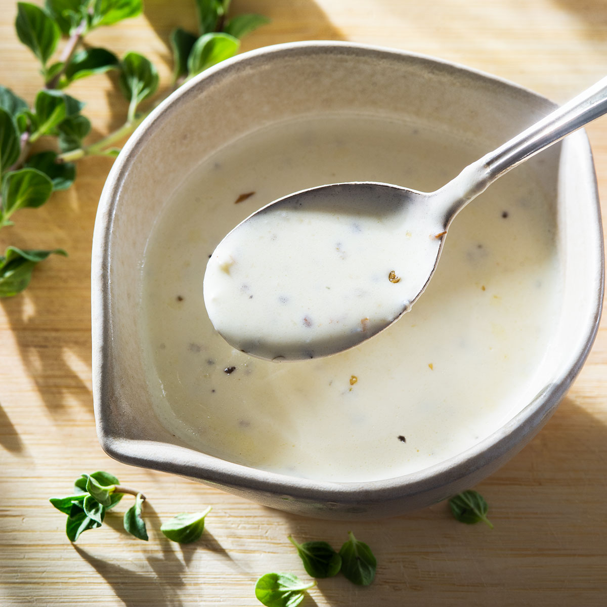 Oregano sauce in a bowl with a spoon.
