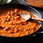 Shrimp and sausage pasta red sauce in a pan.