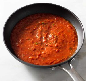 Red pasta sauce in a pan.