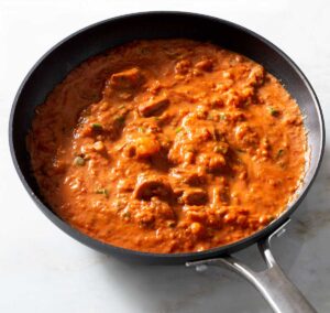 Shrimp and sausage pasta sauce in a pan.