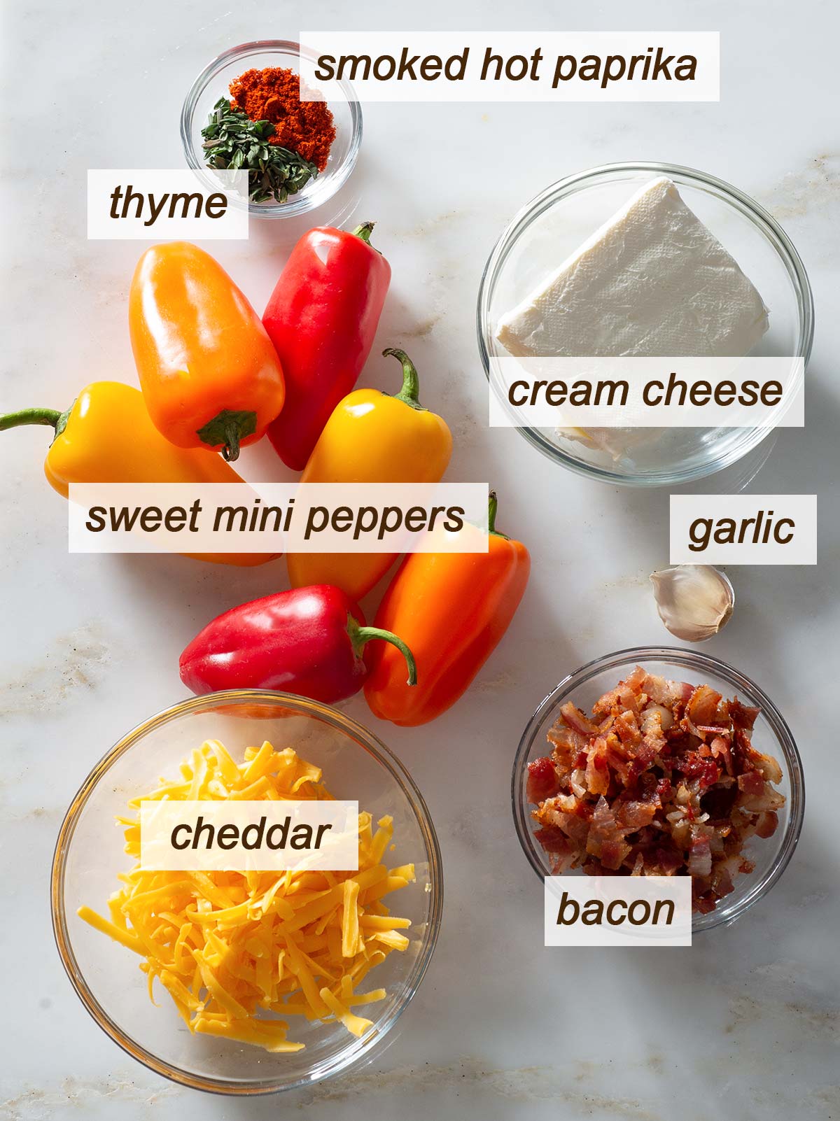 Thyme, smoked paprika, cream cheese, garlic, bacon, cheddar and sweet mini peppers.