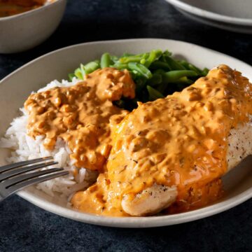 Chicken covered in creamy chipotle sauce with rice and green beans.