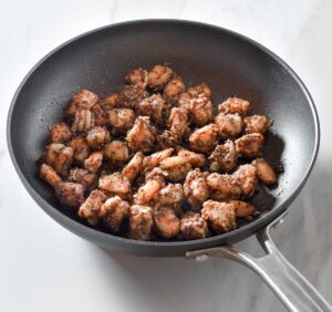 Cooked jerk shrimp in a pan.