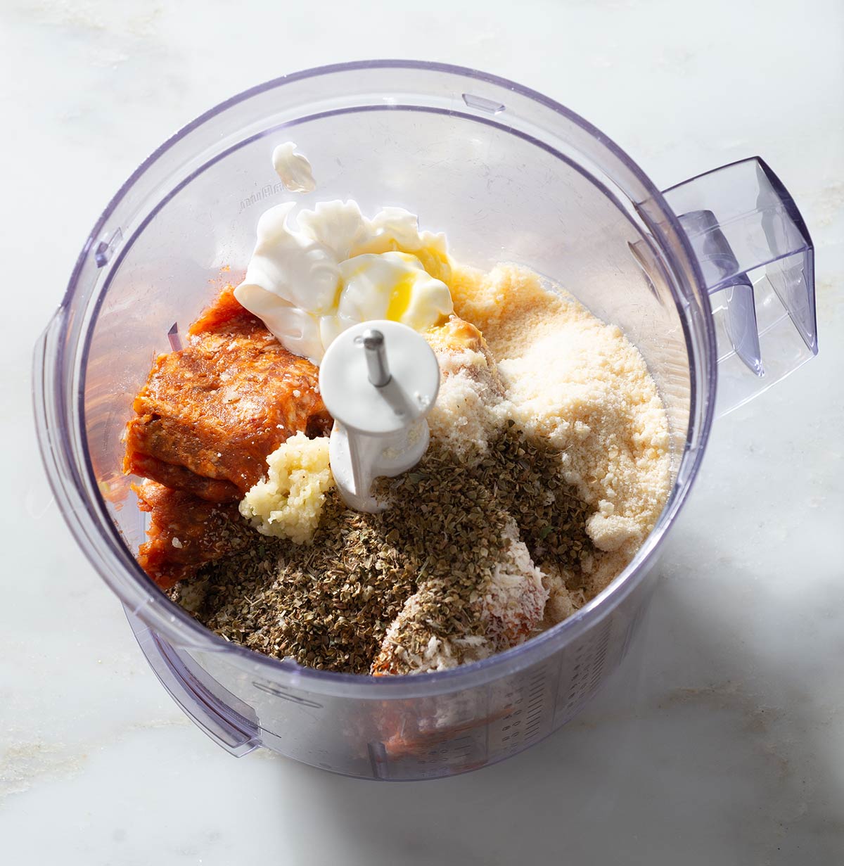 Meatballs ingredients in a food processor.