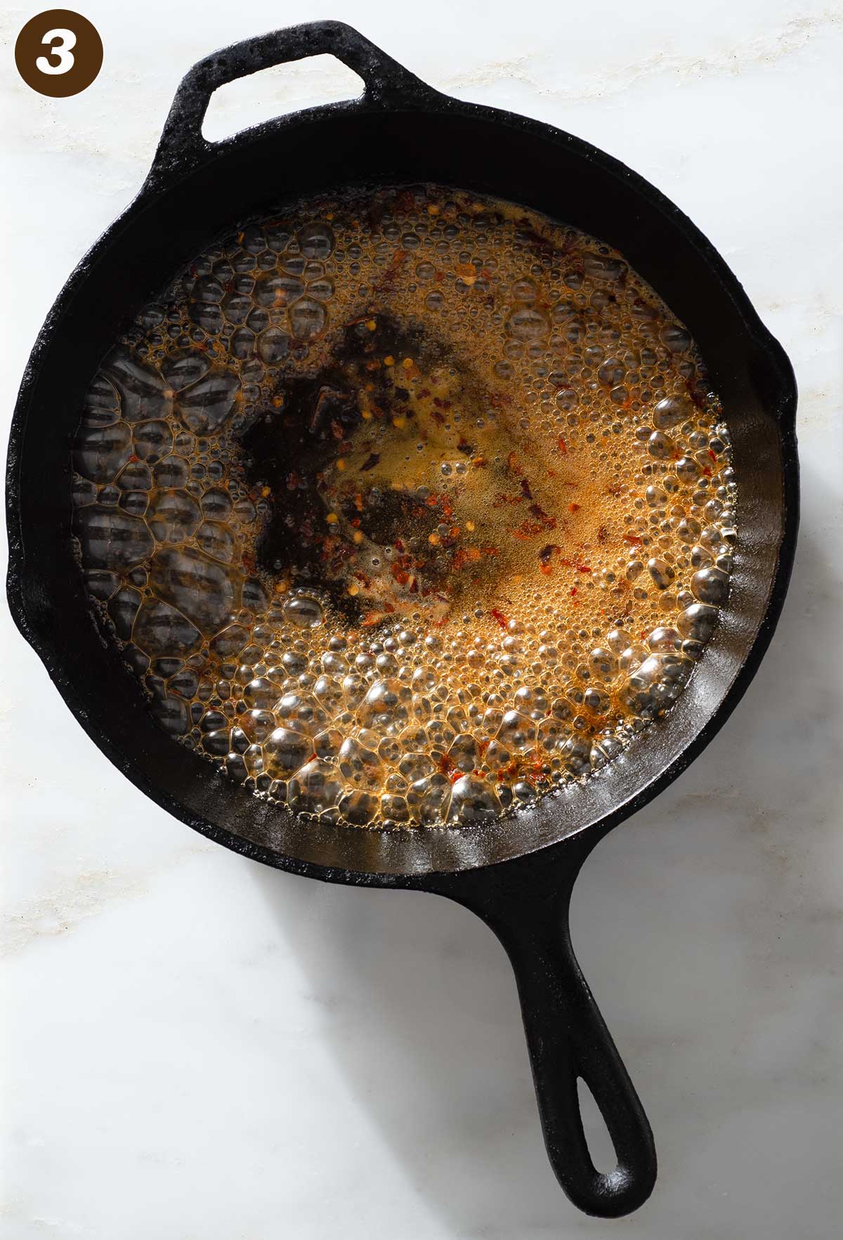 Bubbling sauce in a cast iron pan.