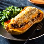 Ground beef butternut squash with green salad on a plate.