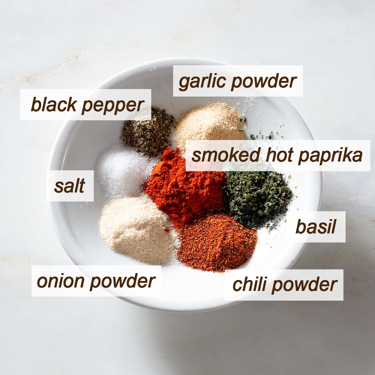 Spices for ground beef on a plate.