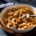 Smoked paprika chicken soup in a bowl with a spoon.