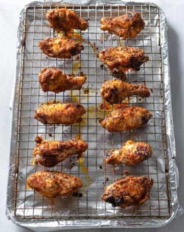 Oven-baked chicken wings on a wire rack.