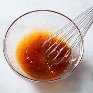 Apricot dipping sauce being whisked in a bowl.