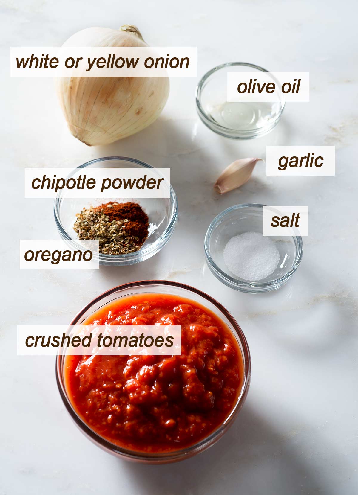 Ingredients for tomato chipotle pizza sauce on a table.