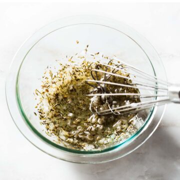 Herbs de Provence marinade being whisked in a bowl.