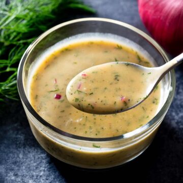 Dill honey mustard sauce in a bowl with a spoon.