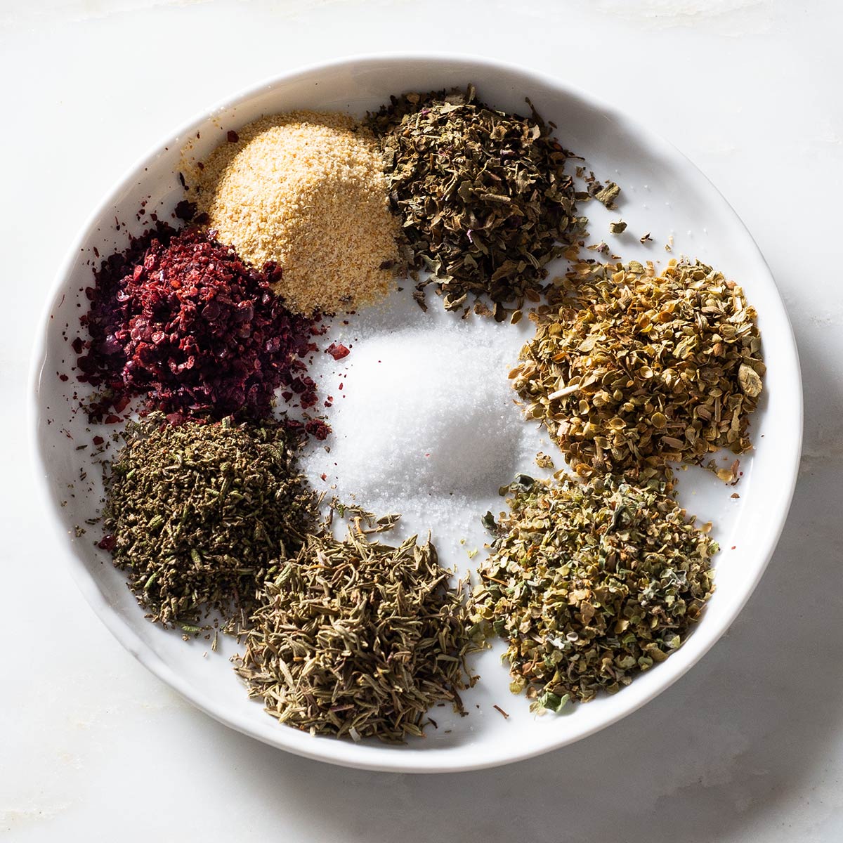 Garlic powder, sumac, salt, thyme, rosemary, marjoram, oregano and basil.
