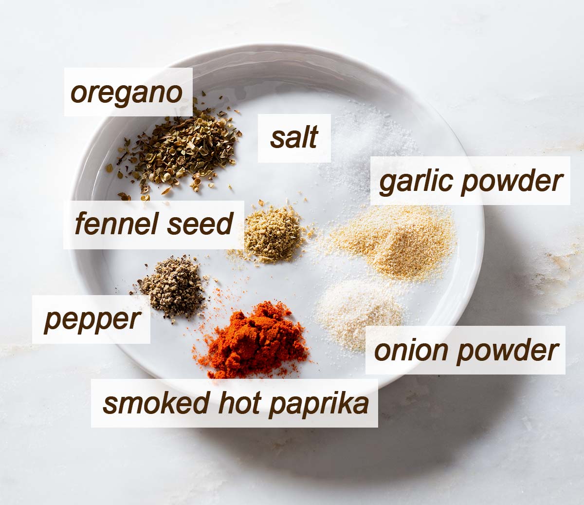 Oregano, salt, fennel seed, pepper, smoked paprika, onion and garlic powder.
