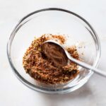 Pork belly seasoning being stirred in a bowl.