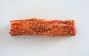 Raw, seasoned pork belly.